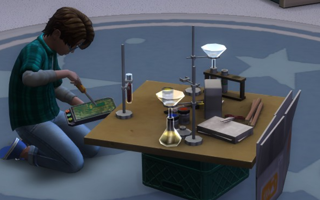 A Sims 4 screenshot, Etan sitting on the ground tinkering with a circuitboard, a small table is set up in front of him with chemistry equipment and scraps of paper.